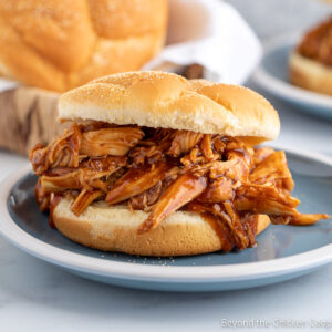 Shredded BBQ chicken on a bun.