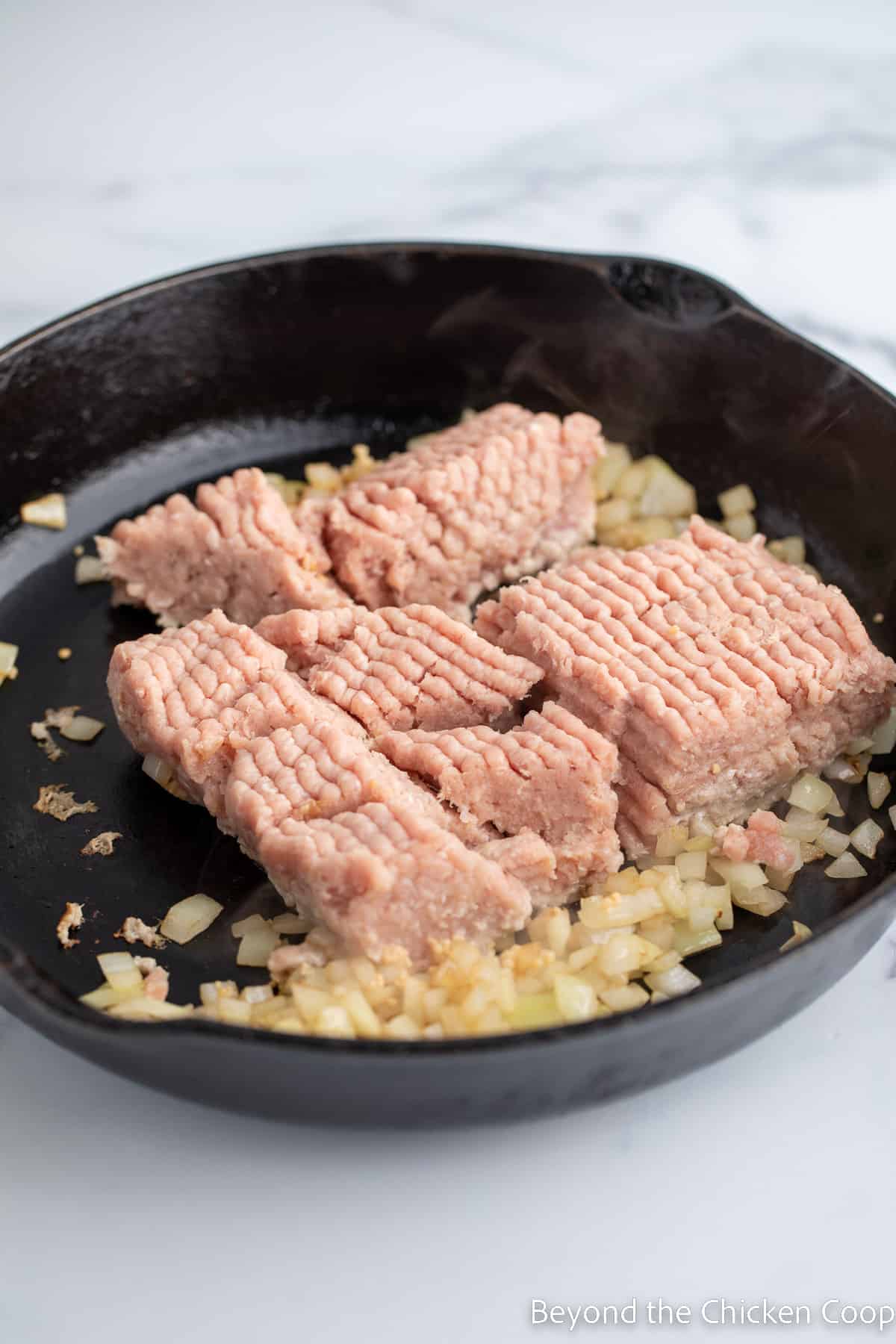 Ground turkey in a cast iron skillet.