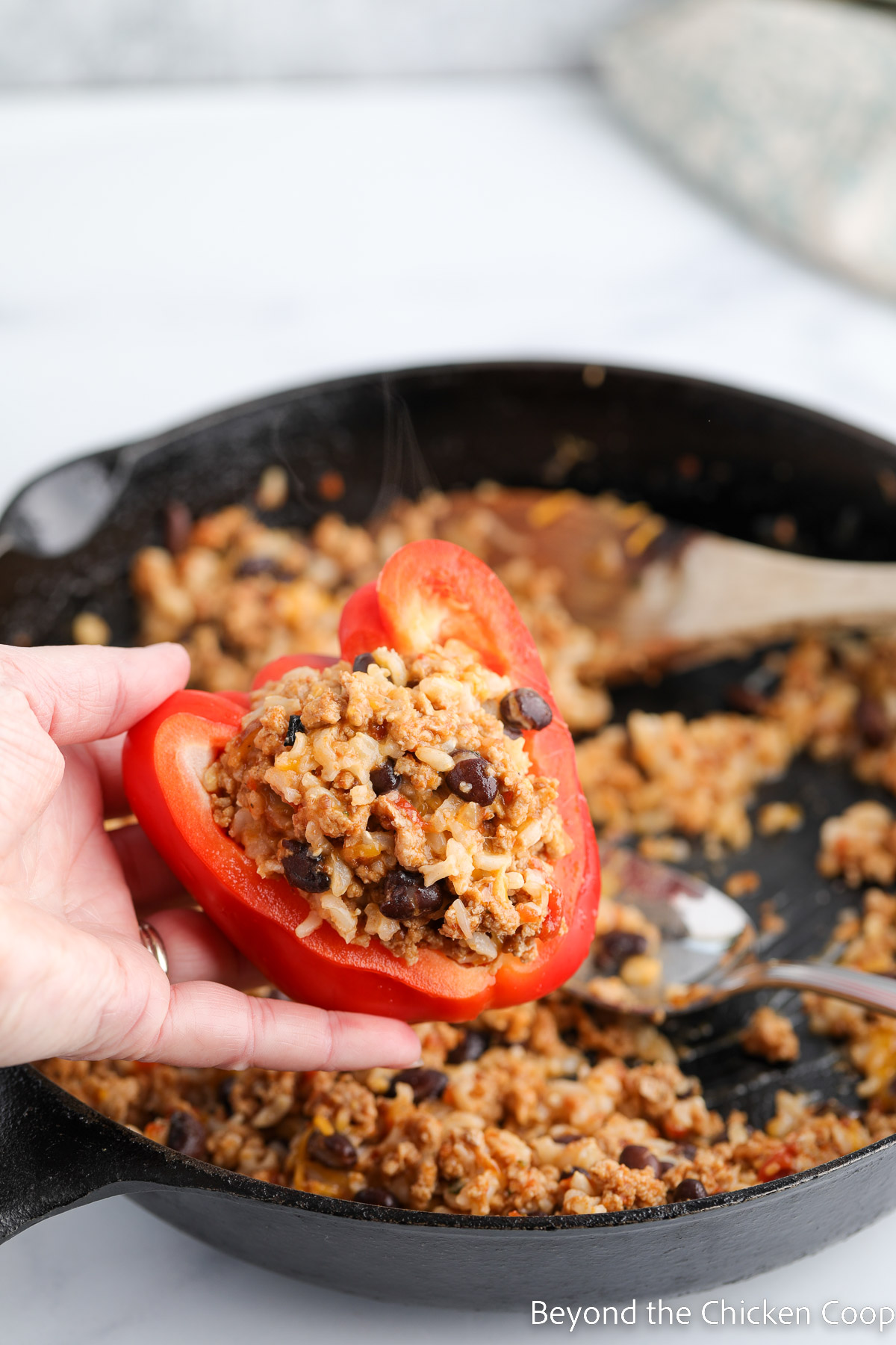 Filling a red bell pepper.