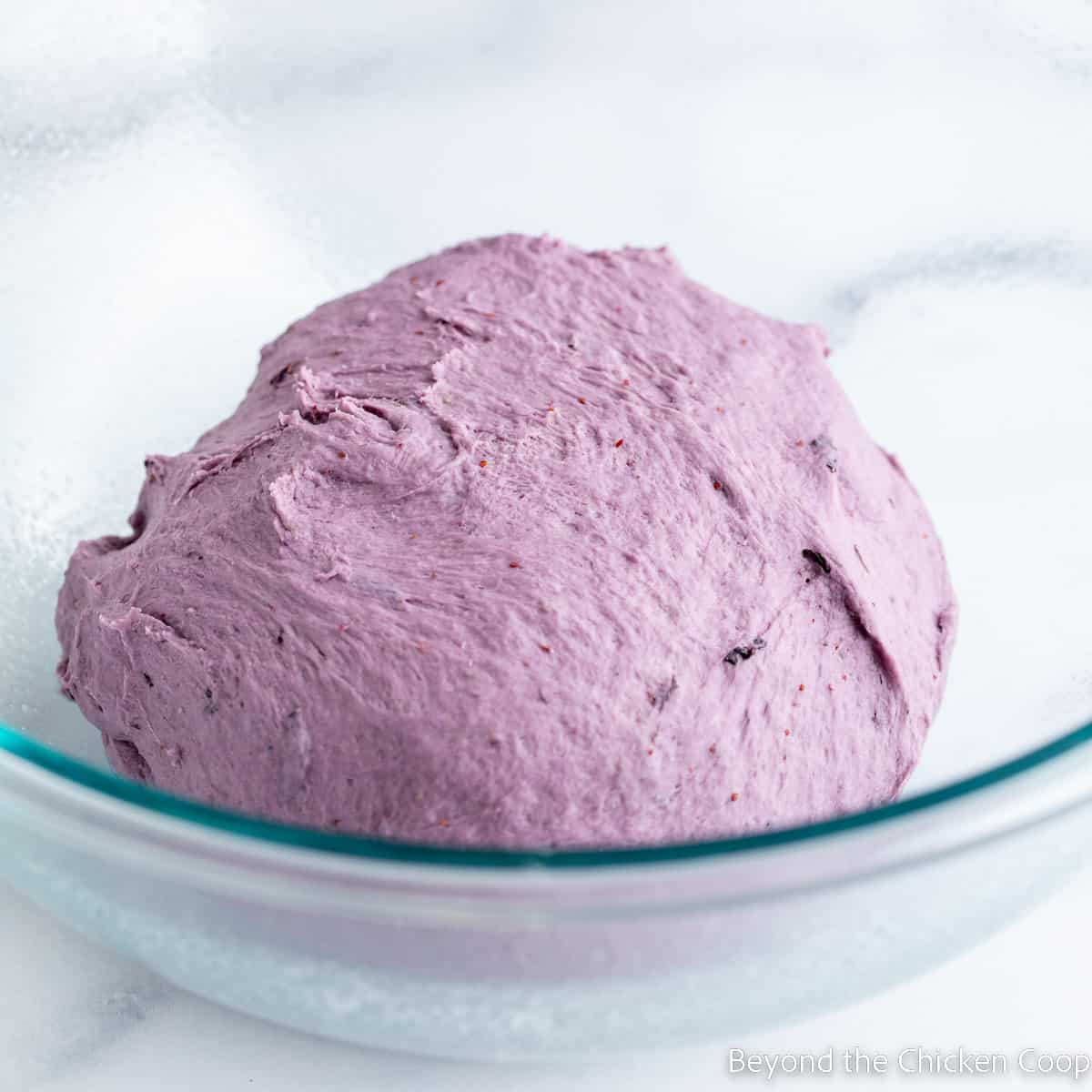 A brightly colored dough in a bowl. 