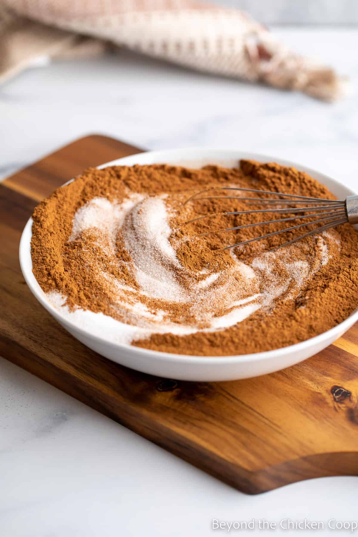 Cinnamon and sugar swirled together in a bowl. 