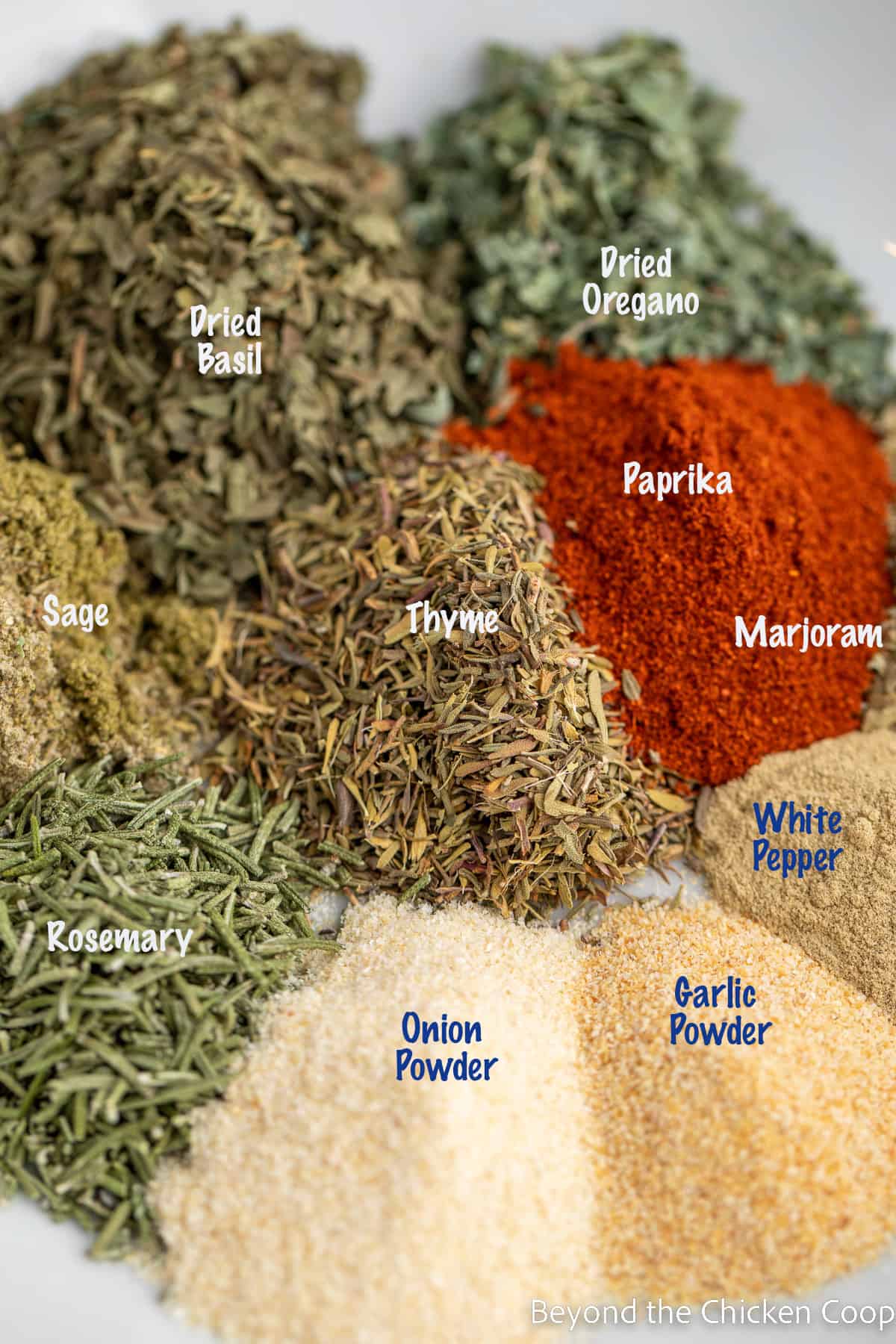 A variety of herbs and spices in a bowl. 