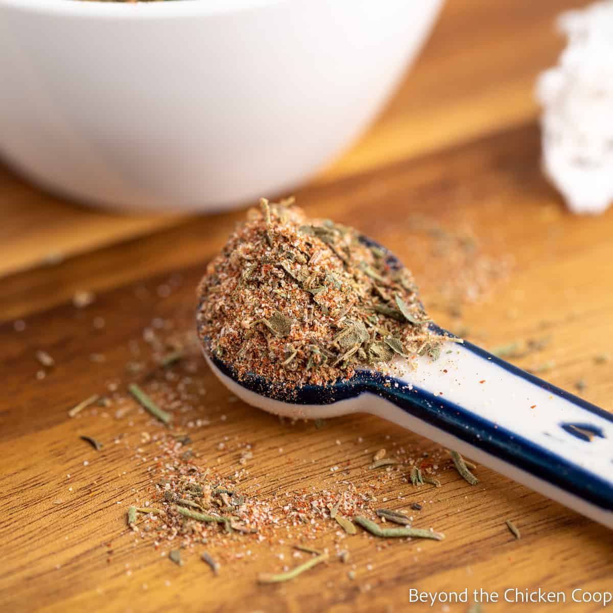 Spices in a teaspoon on a wooden board. 