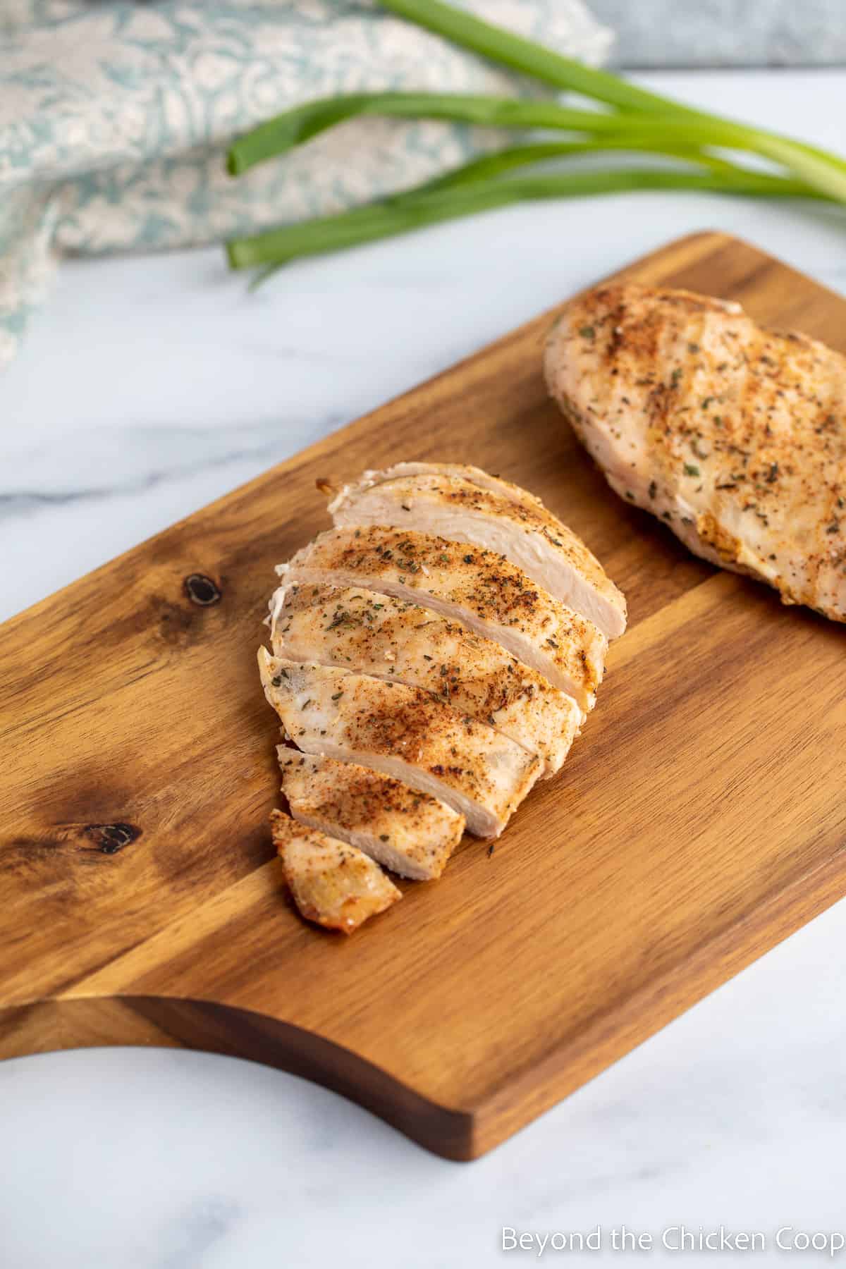 Sliced chicken breast on a cutting board. 