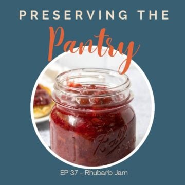 A glass canning jar filled with red jam.