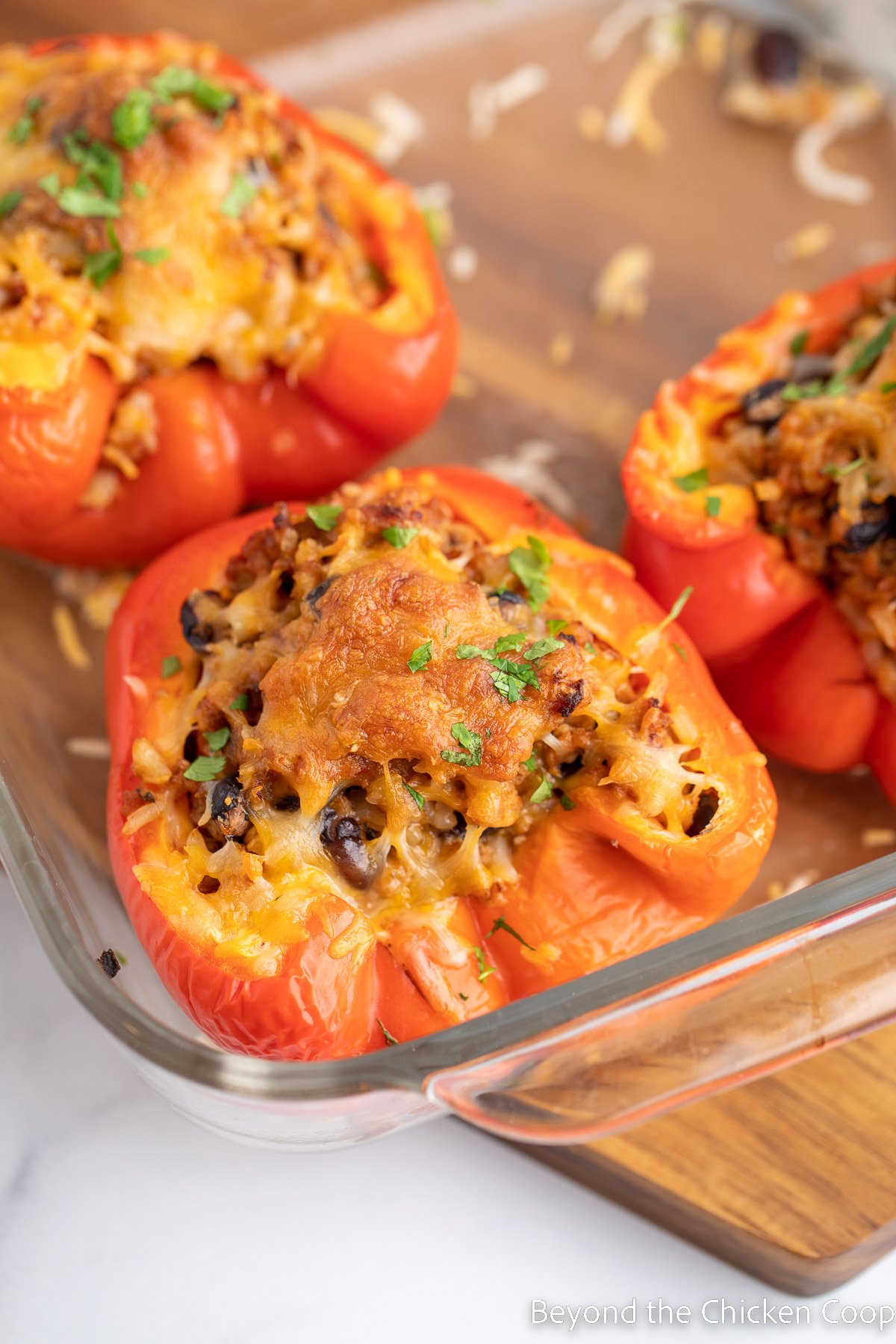 Baked stuffed peppers in a glass baking dish. 