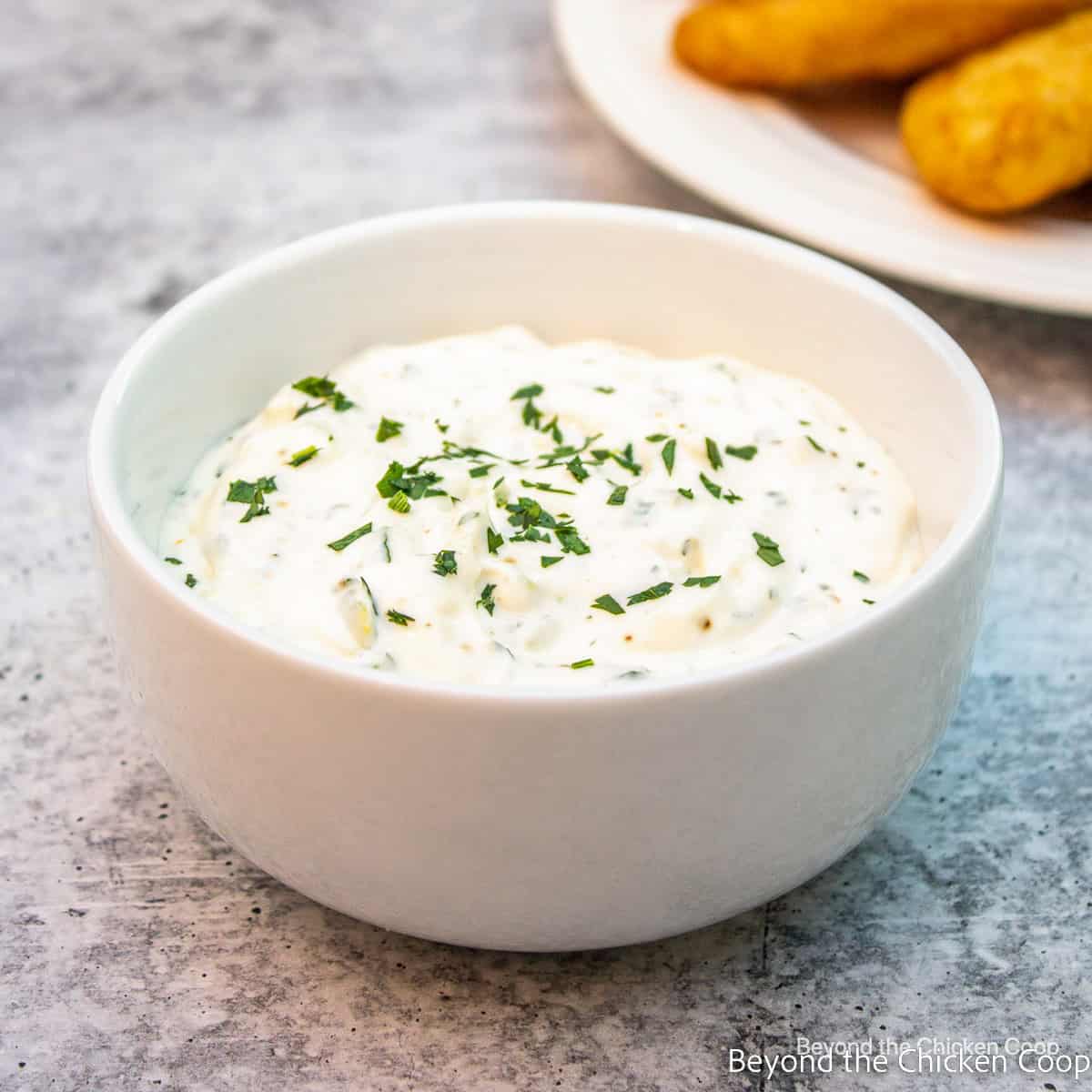 A white bowl filled with tartar sauce. 