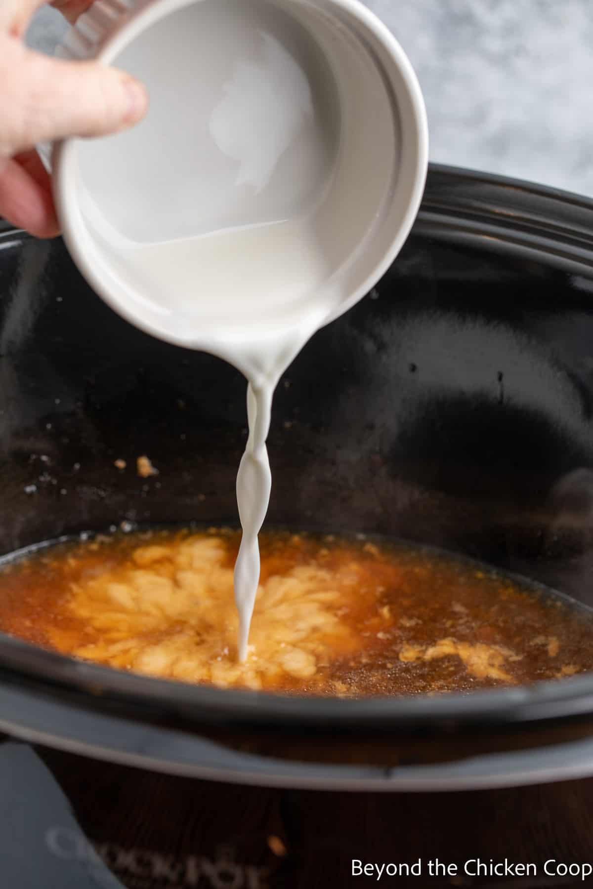 Pouring cornstarch into a crockpot. 