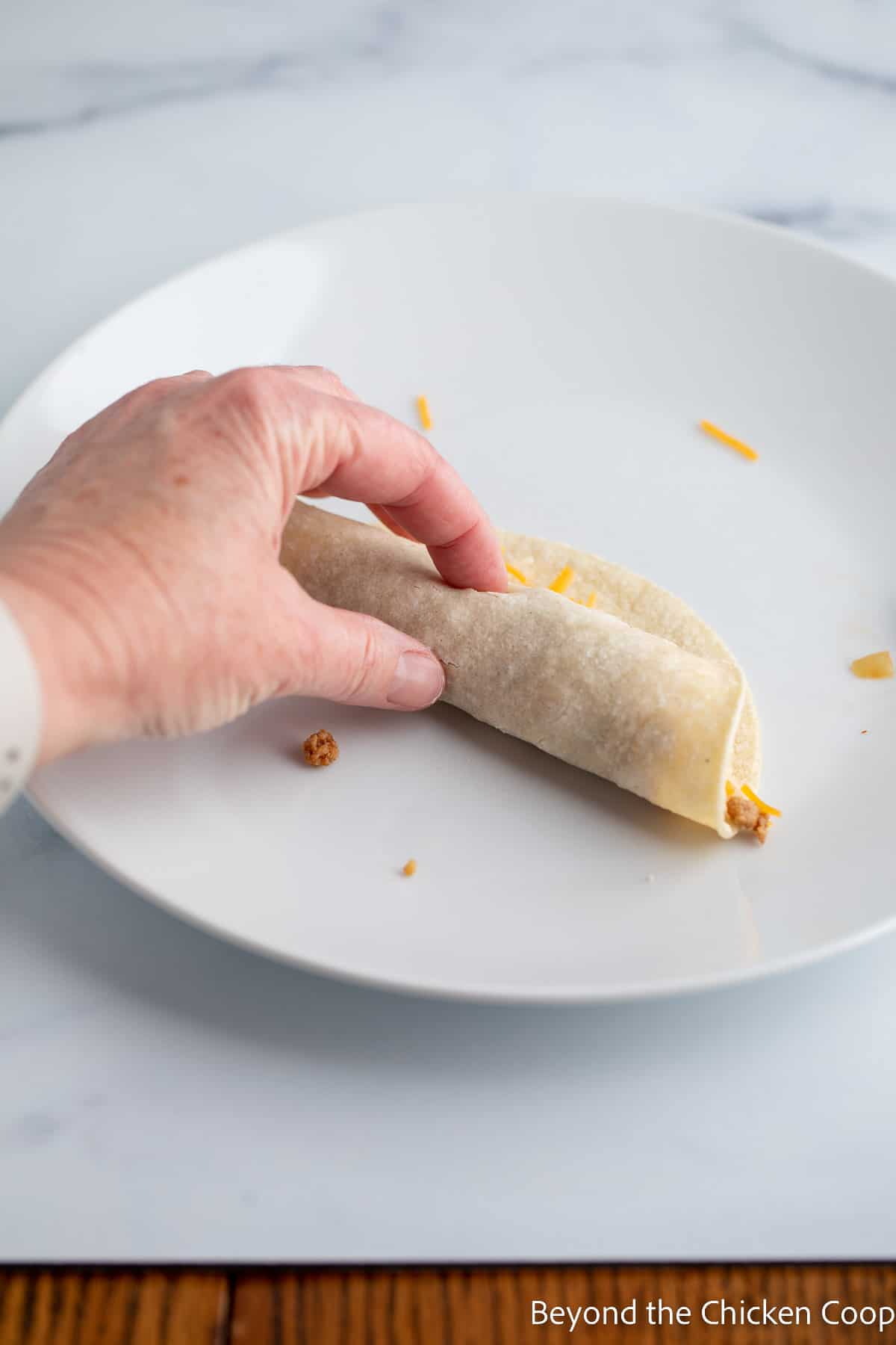 Rolling up a tortilla.