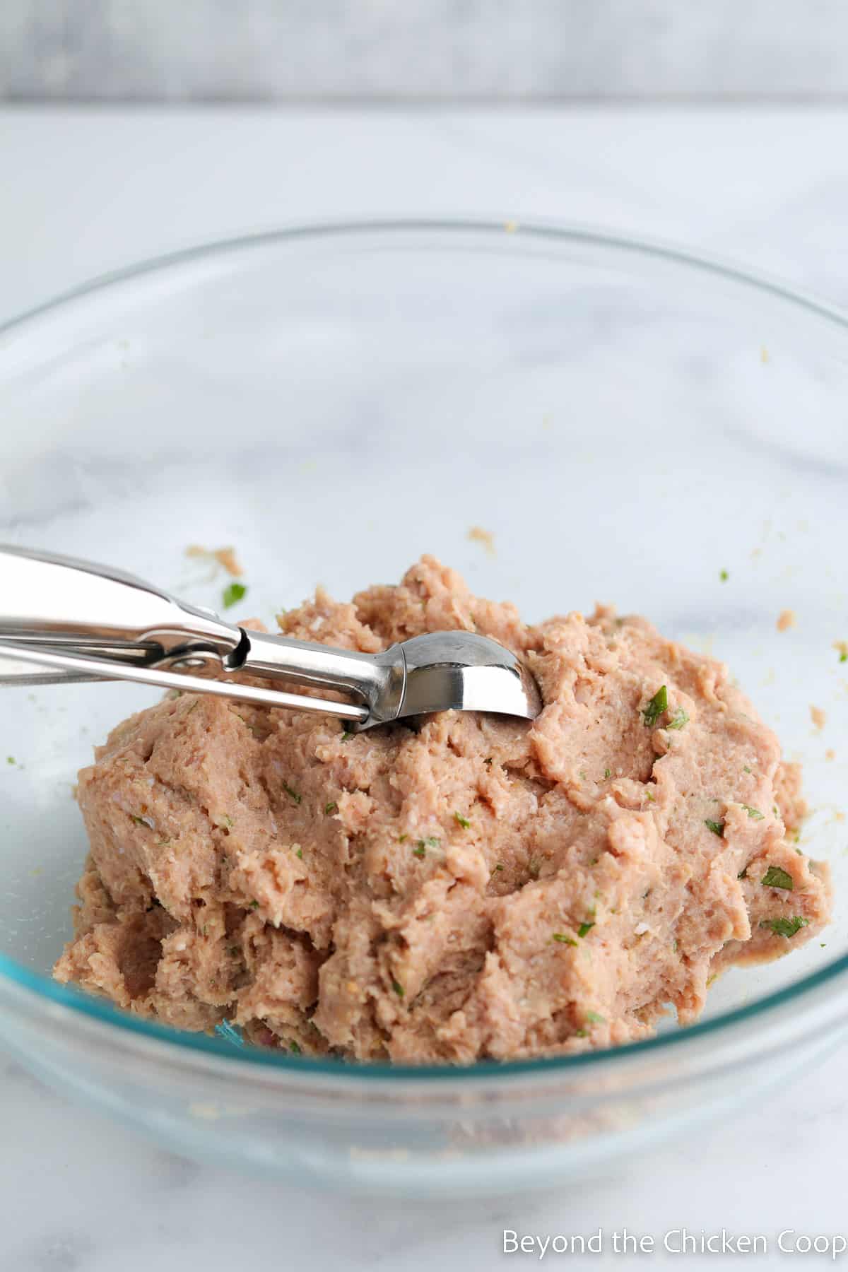 Scooping up a meat mixture. 