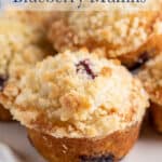 Blueberry muffins on a white cake stand.