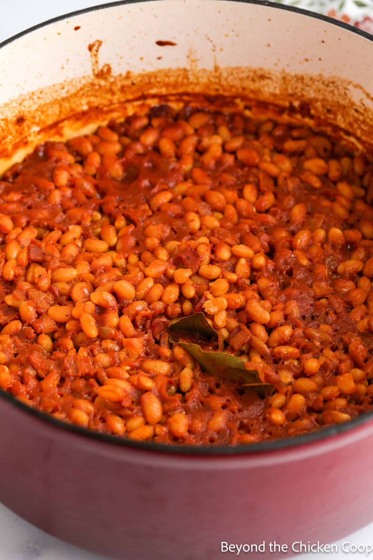 A pot of baked beans filled with cooked beans. 