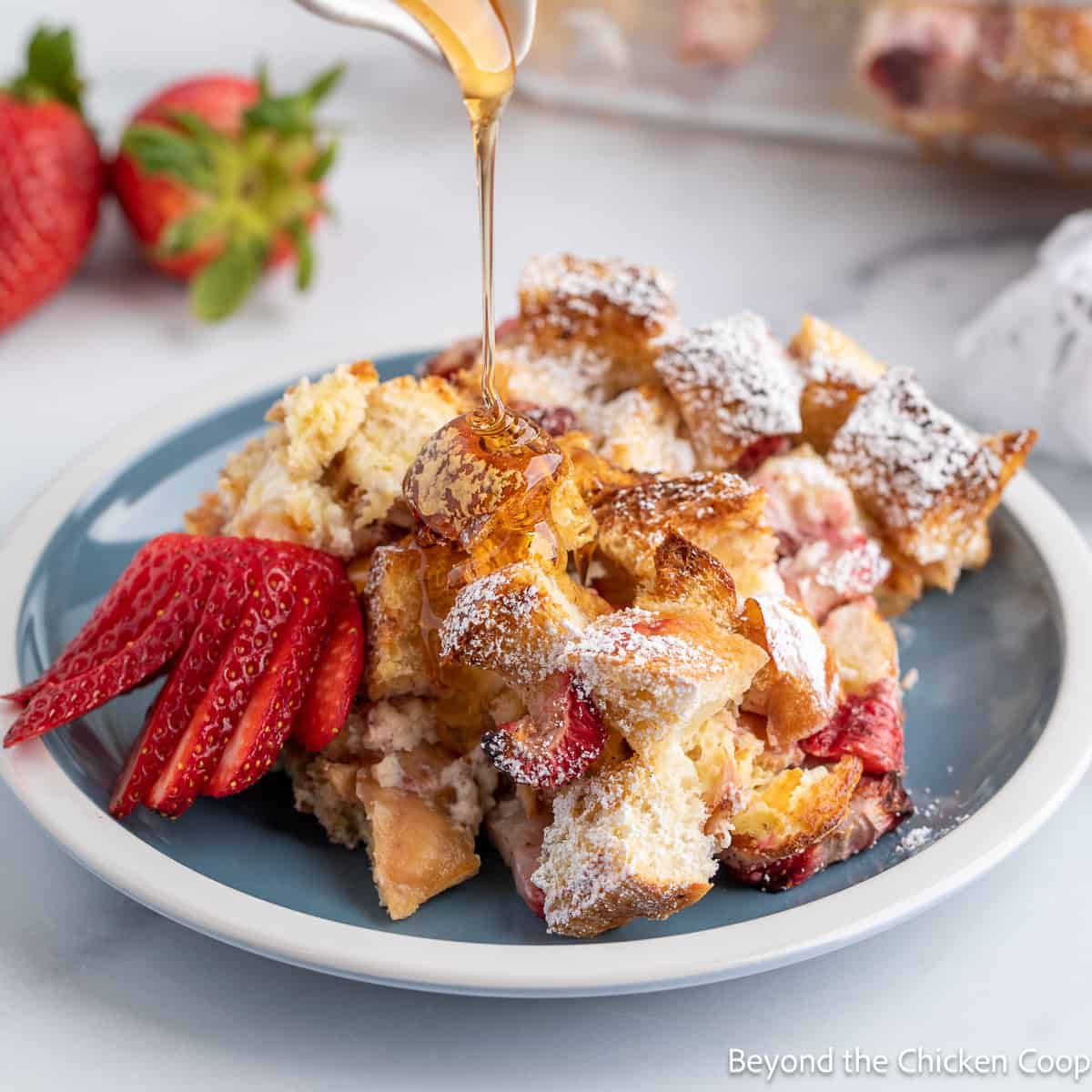 French toast with strawberries on a blue plate.