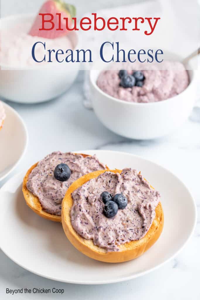 Bagels topped with cream cheese and fresh blueberries.