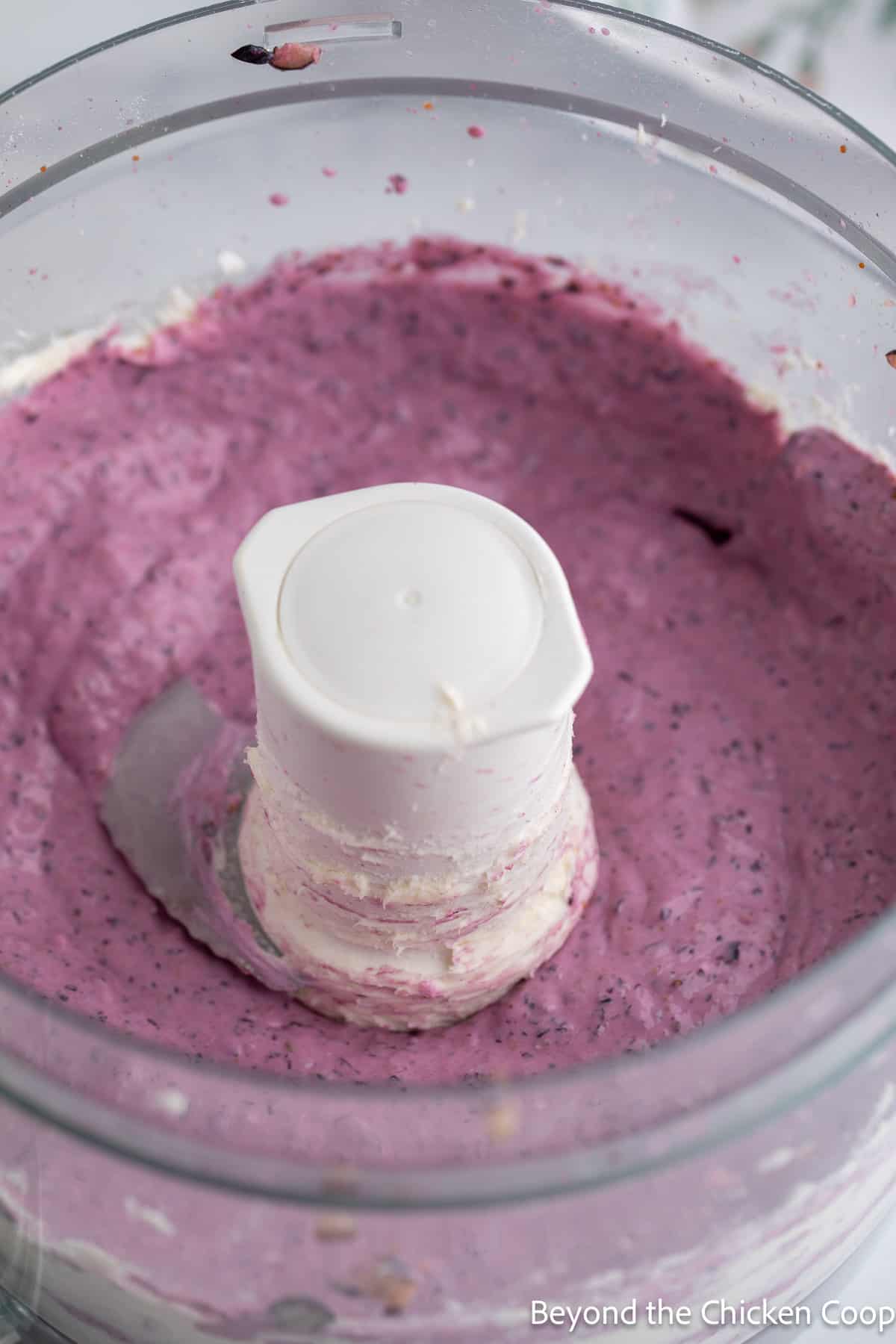 Pureed blueberries in a food processor. 