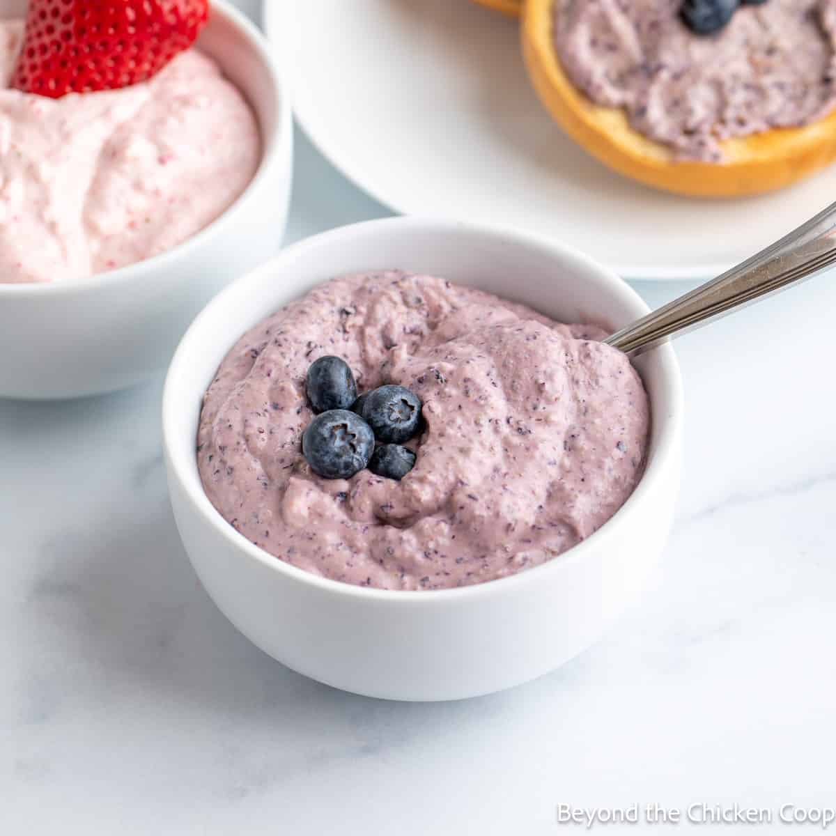 A bowl filled with blueberry cream cheese.