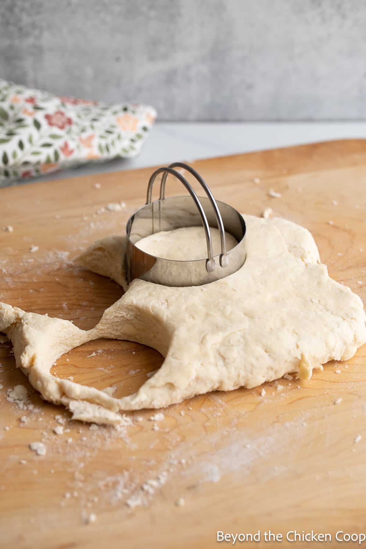 Cutting biscuits with a round biscuit cutter.