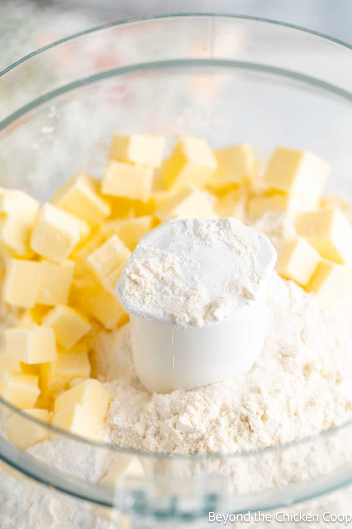 Small cubes of butter and flour in a food processor.