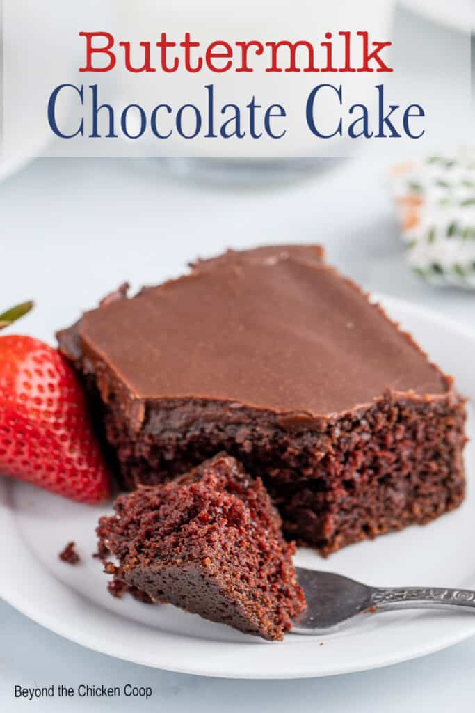A square of chocolate cake on a plate.