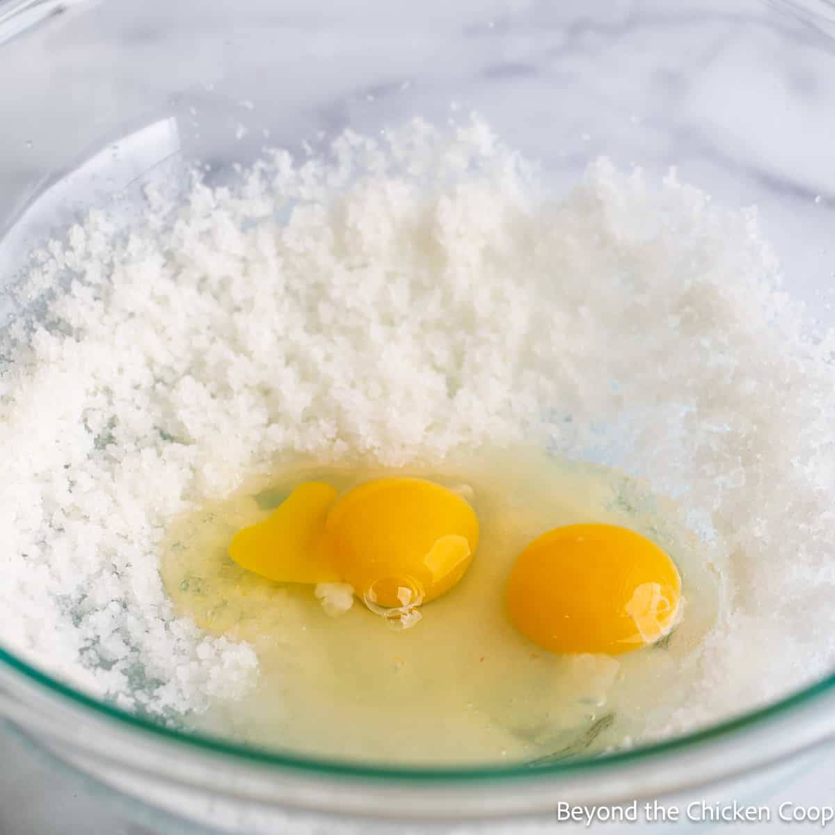 A bowl with sugar and eggs. 