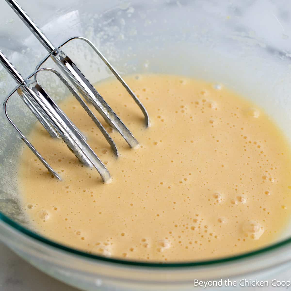 Mixing cookie dough in a glass bowl. 