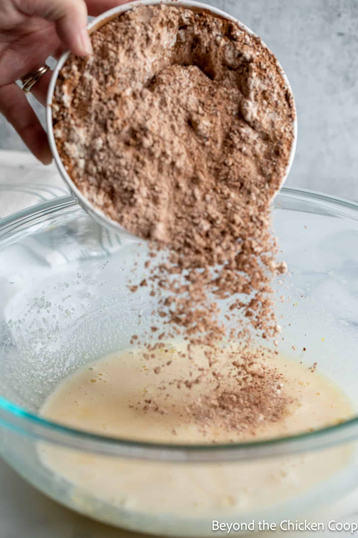 Pouring flour into a bowl. 