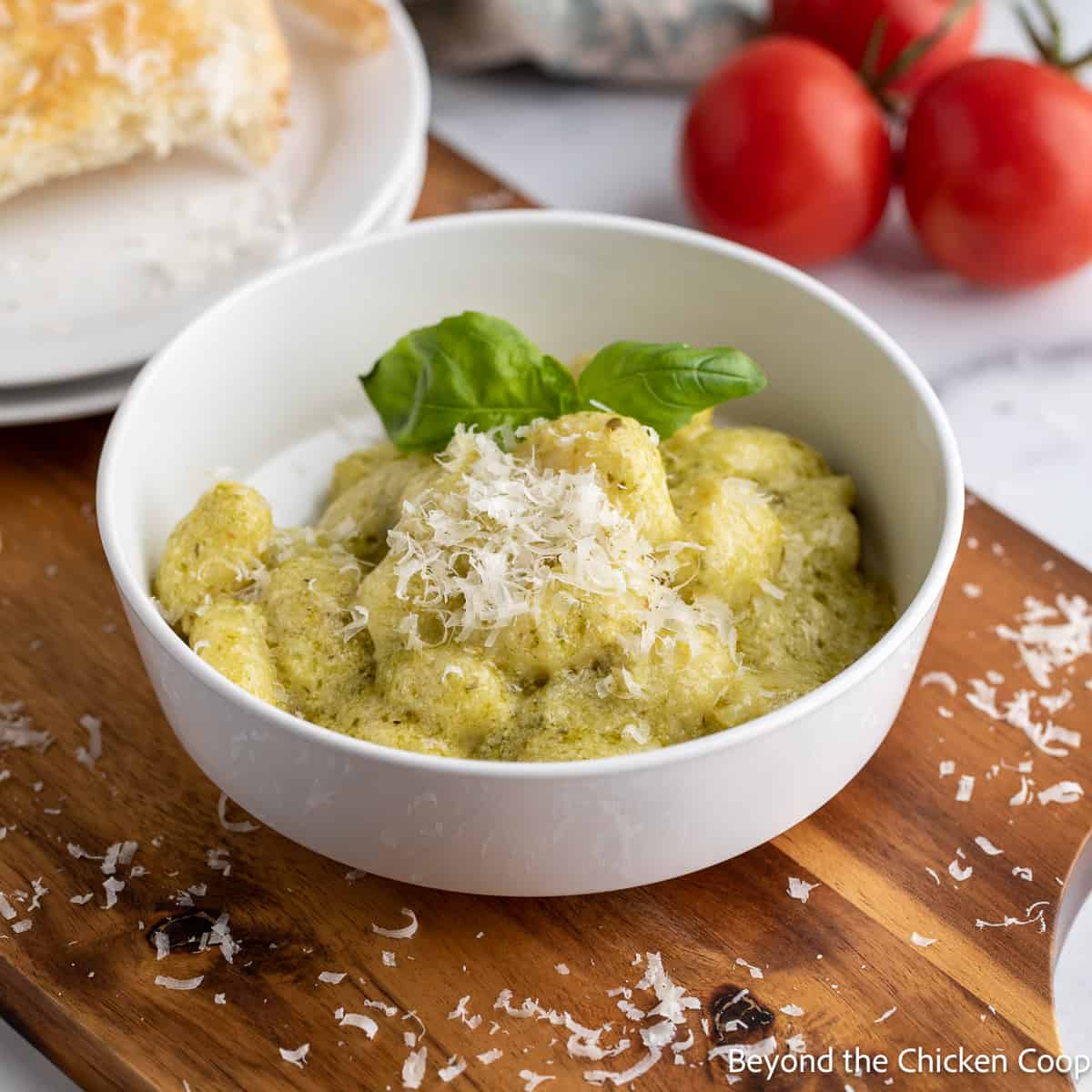 A bowl filled with gnocchi with pesto sauce. 