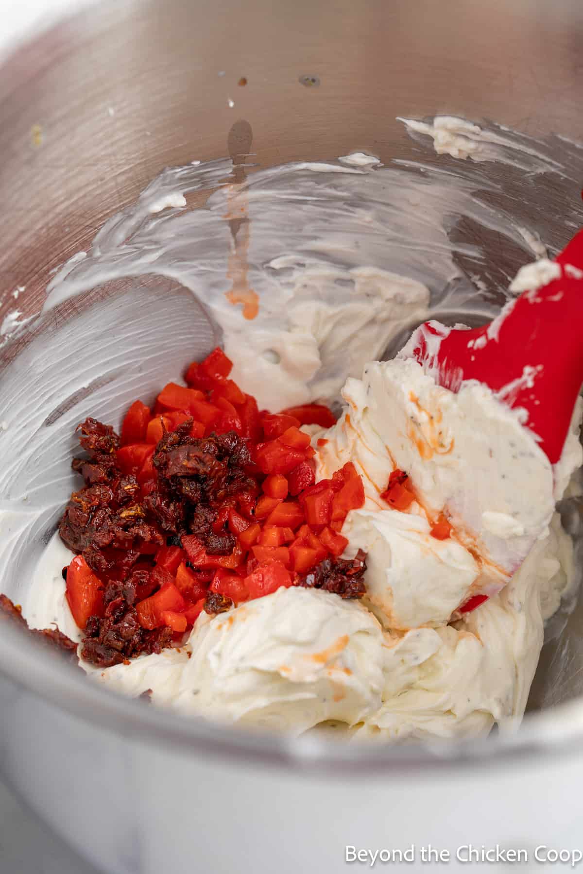 Chopped peppers and sun dried tomatoes added to cream cheese. 