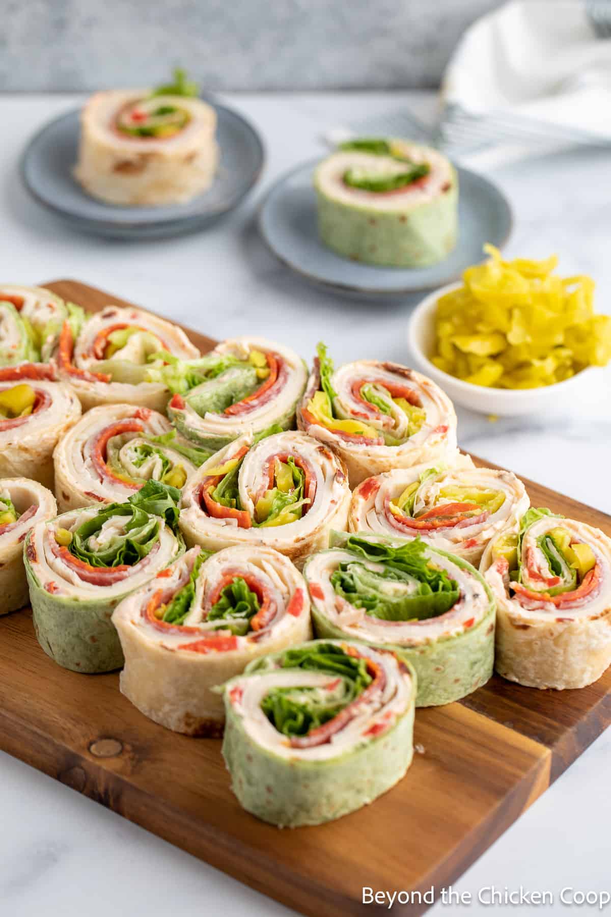 Green and white pinwheels on a wooden board. 