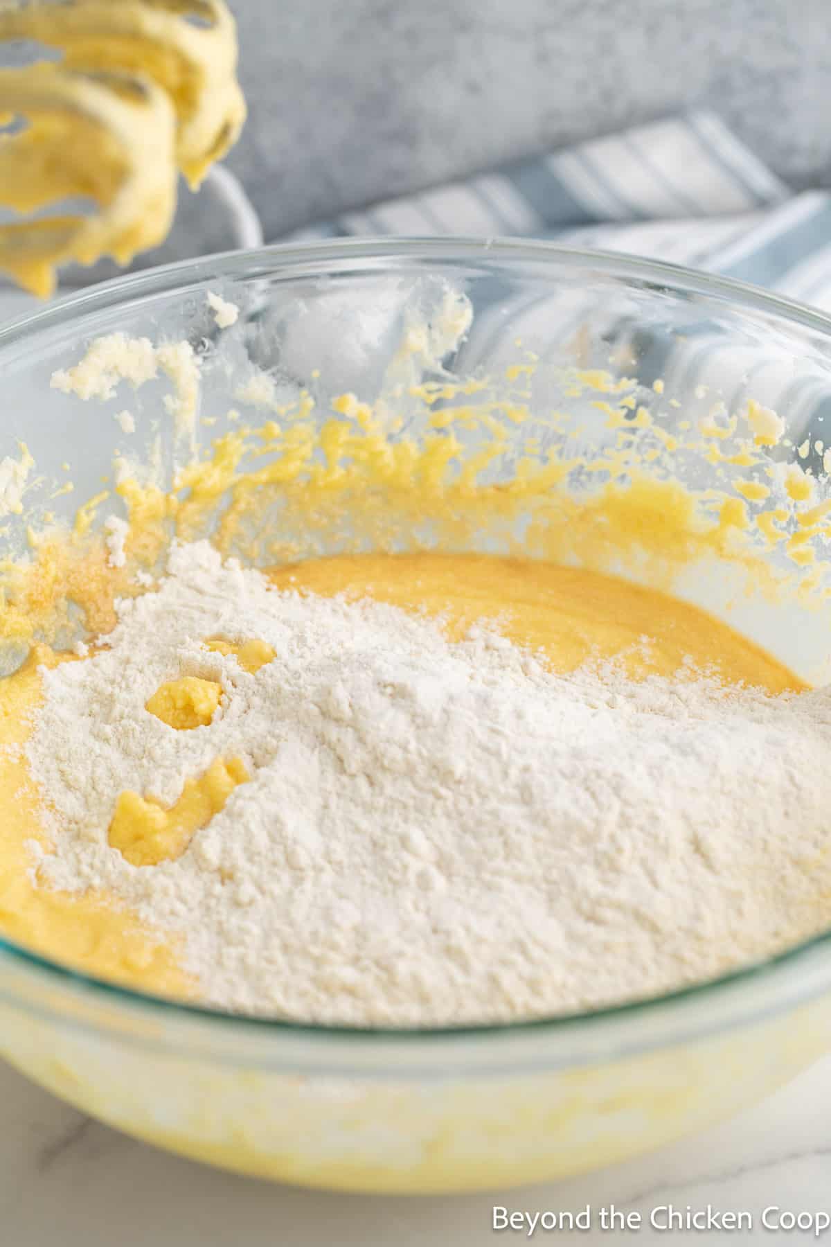 Mixing flour into a cake batter. 