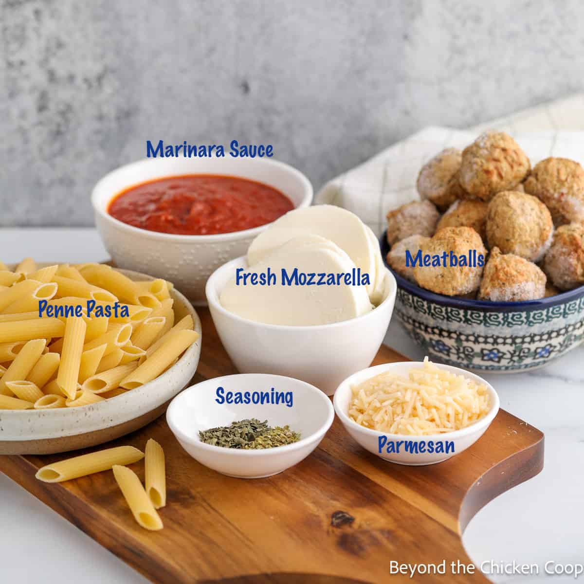 Ingredients in small bowls for making a baked pasta. 
