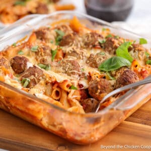 A casserole dish filled with pasta and meatballs.