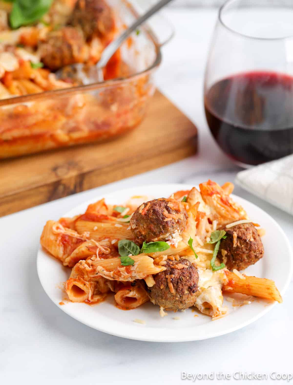 Pasta and meatballs on a white plate. 