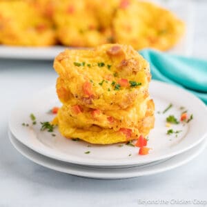 Mini frittatas stacked on a plate.
