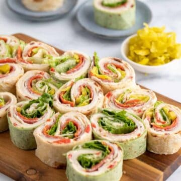 Green and white pinwheels on a wooden board.