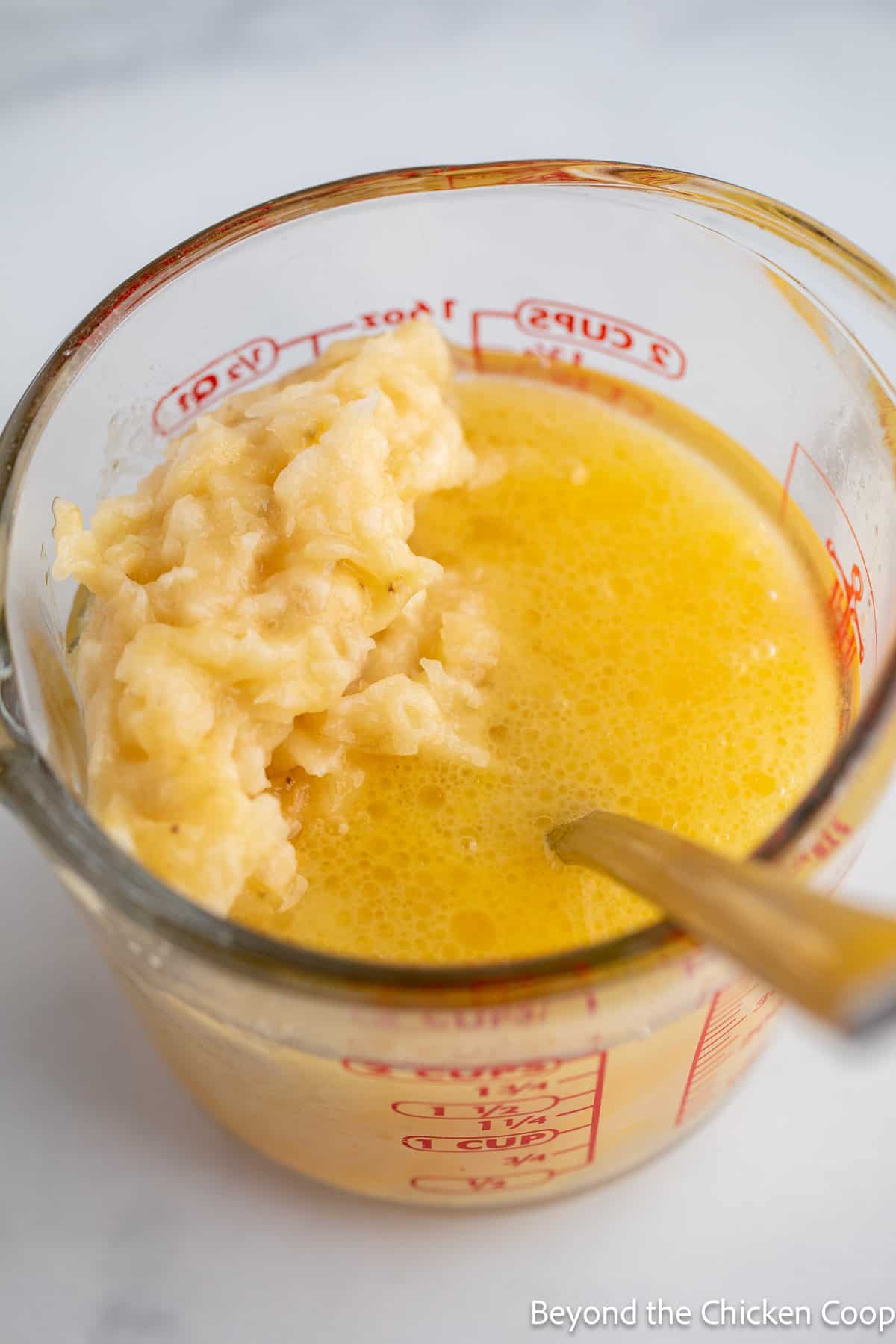 Mixing mashed bananas with oil and eggs. 