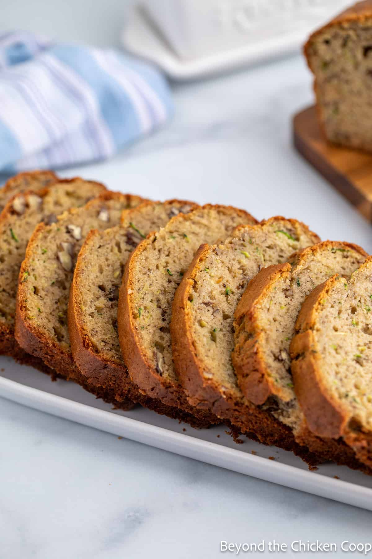 Slices of banana bread on a white platter. 