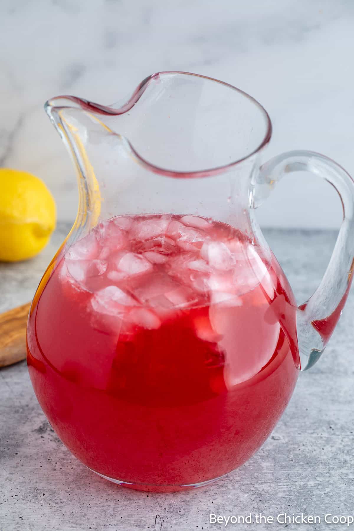 A red lemonade in a glass pitcher.