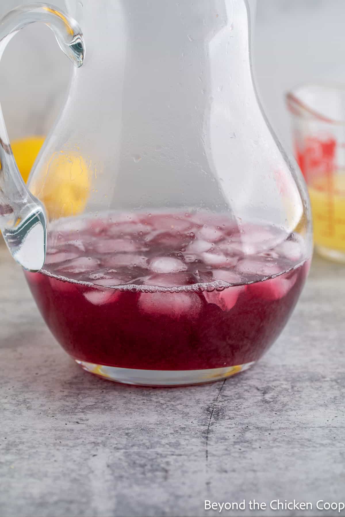 Ice with blackberry juice in a pitcher. 