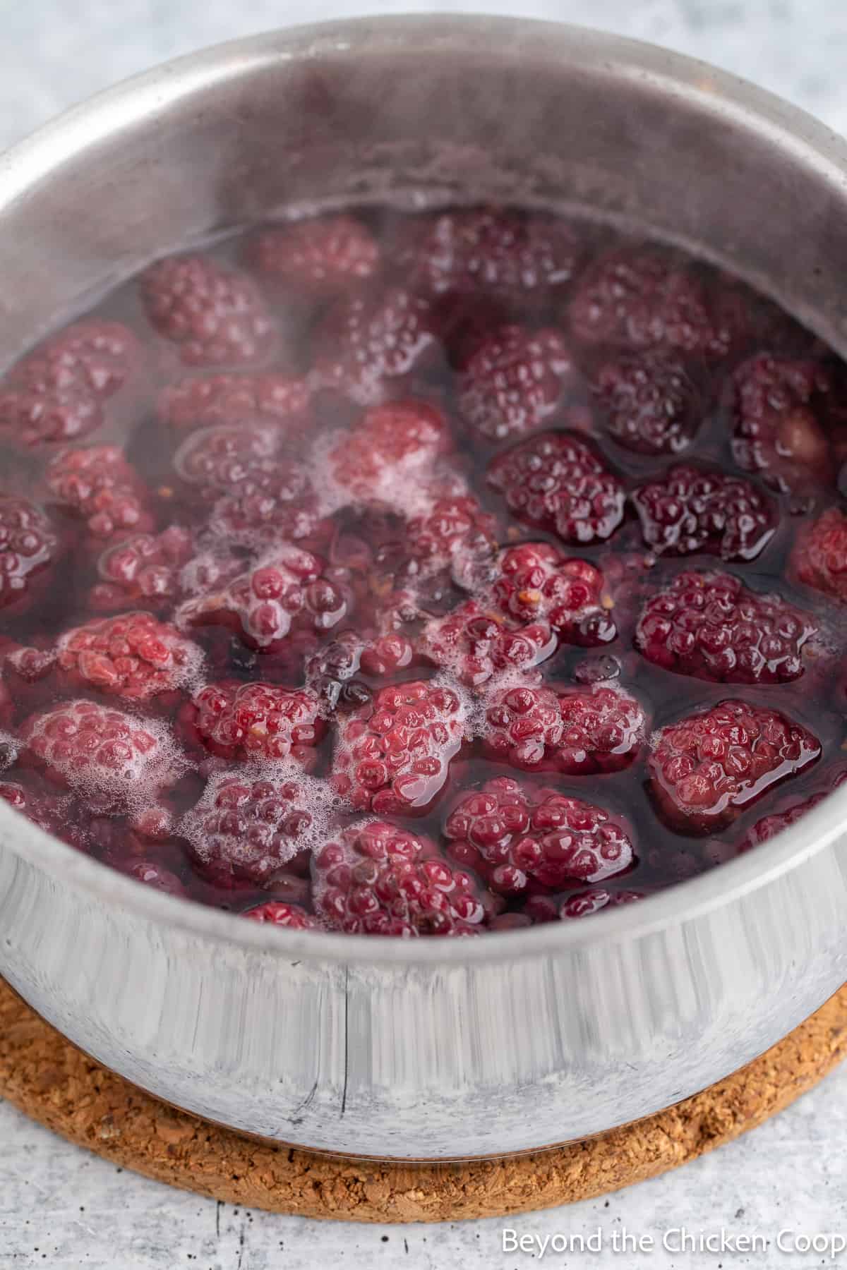 Cooking blackberries in a pot. 