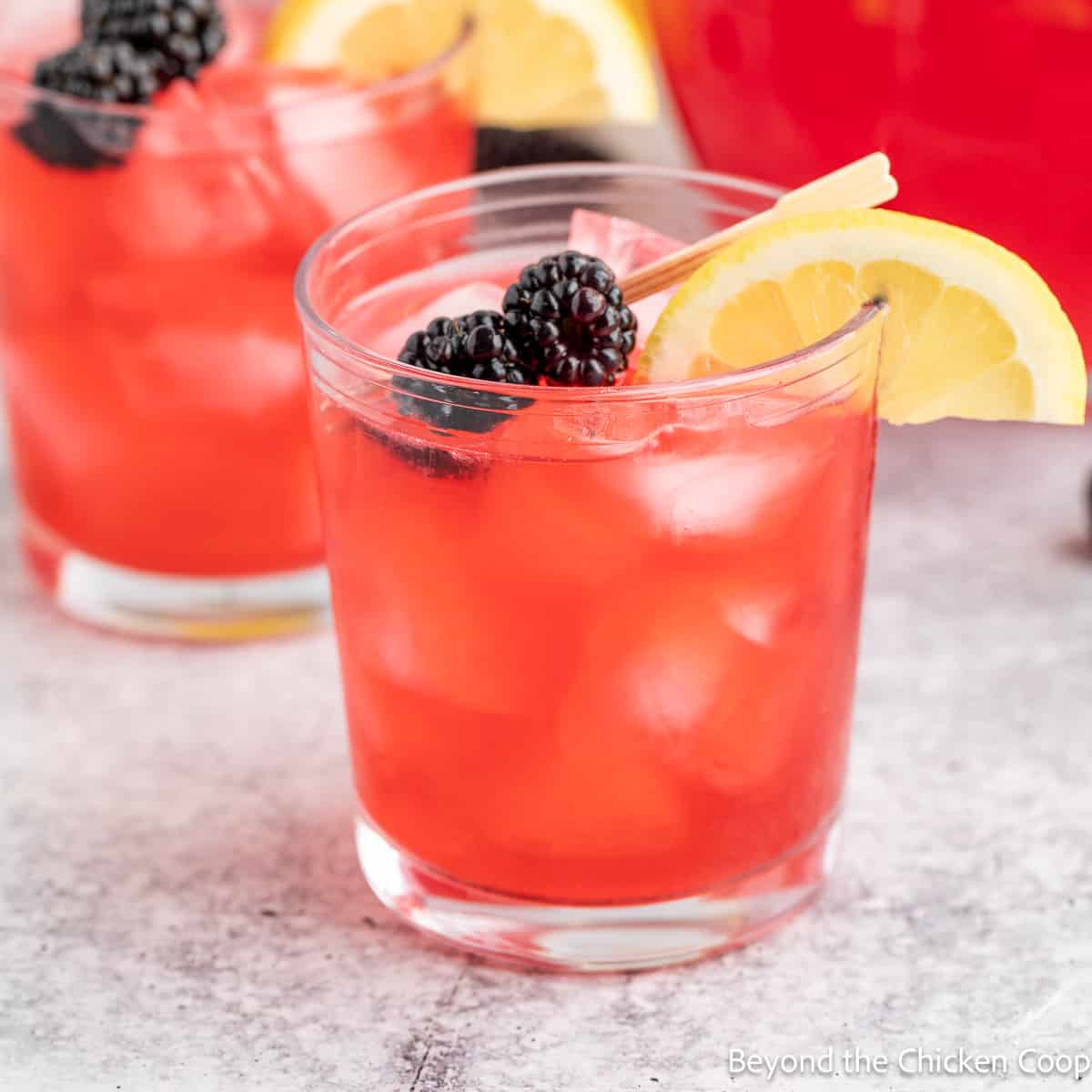 A glass filled with blackberry lemonade.