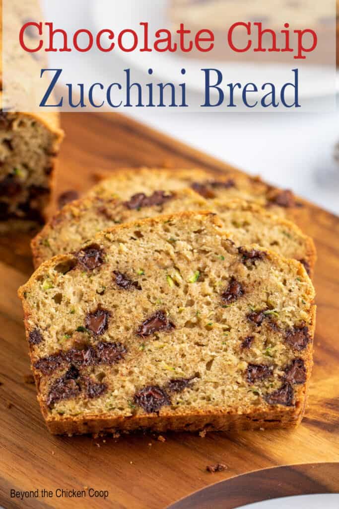 Two slices of bread studded with chocolate chips on a wooden board.