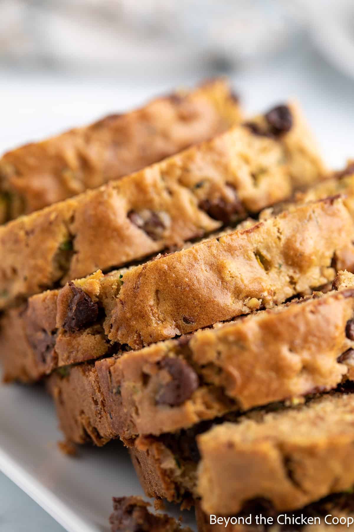 Sliced zucchini bread on a platter. 