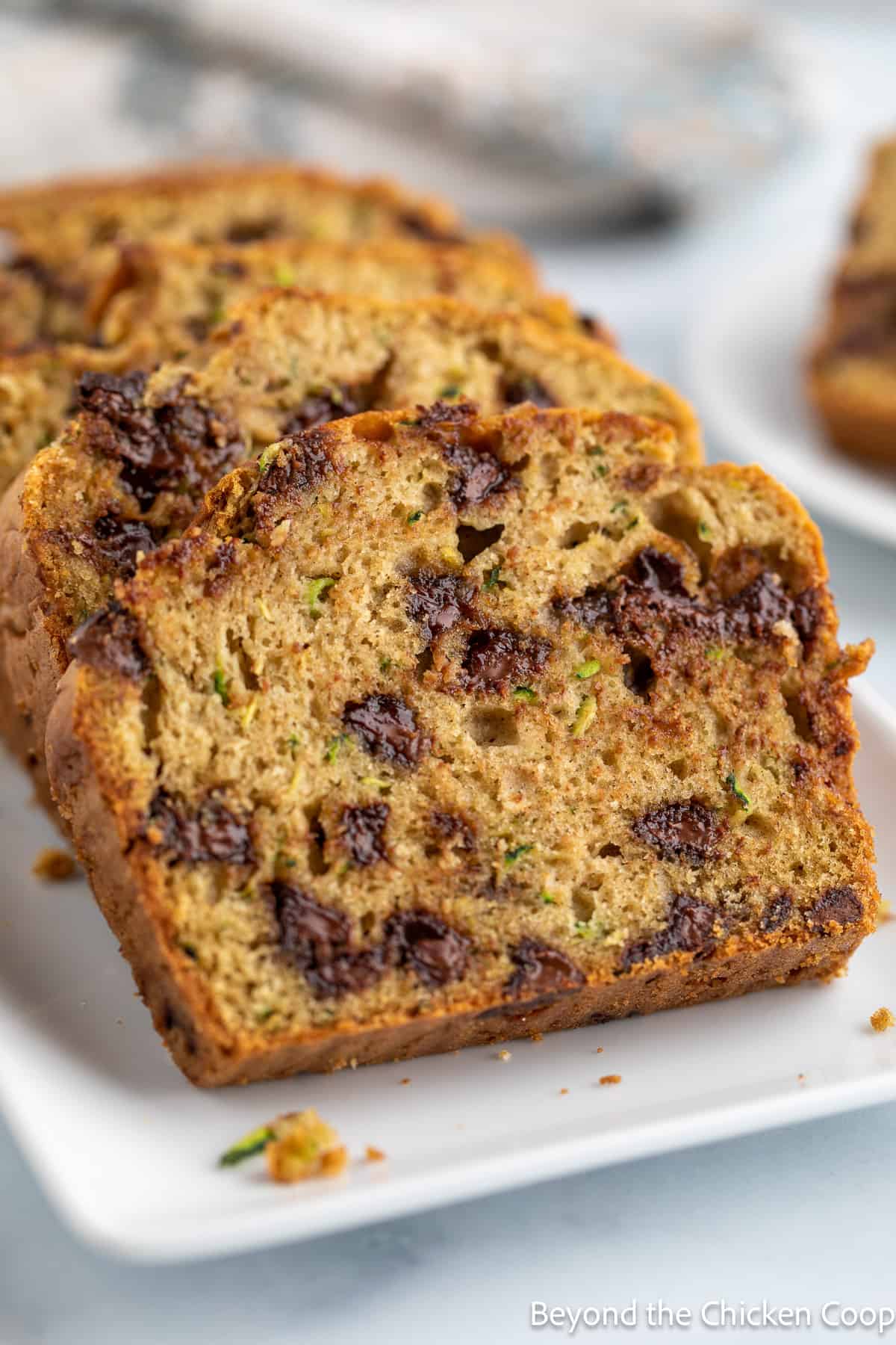 Slices of zucchini bread on a white platter. 