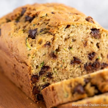 Zucchini bread with chocolate chips on a cutting board.