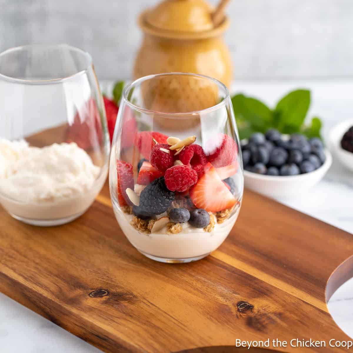 Berries with granola and yogurt in a glass.