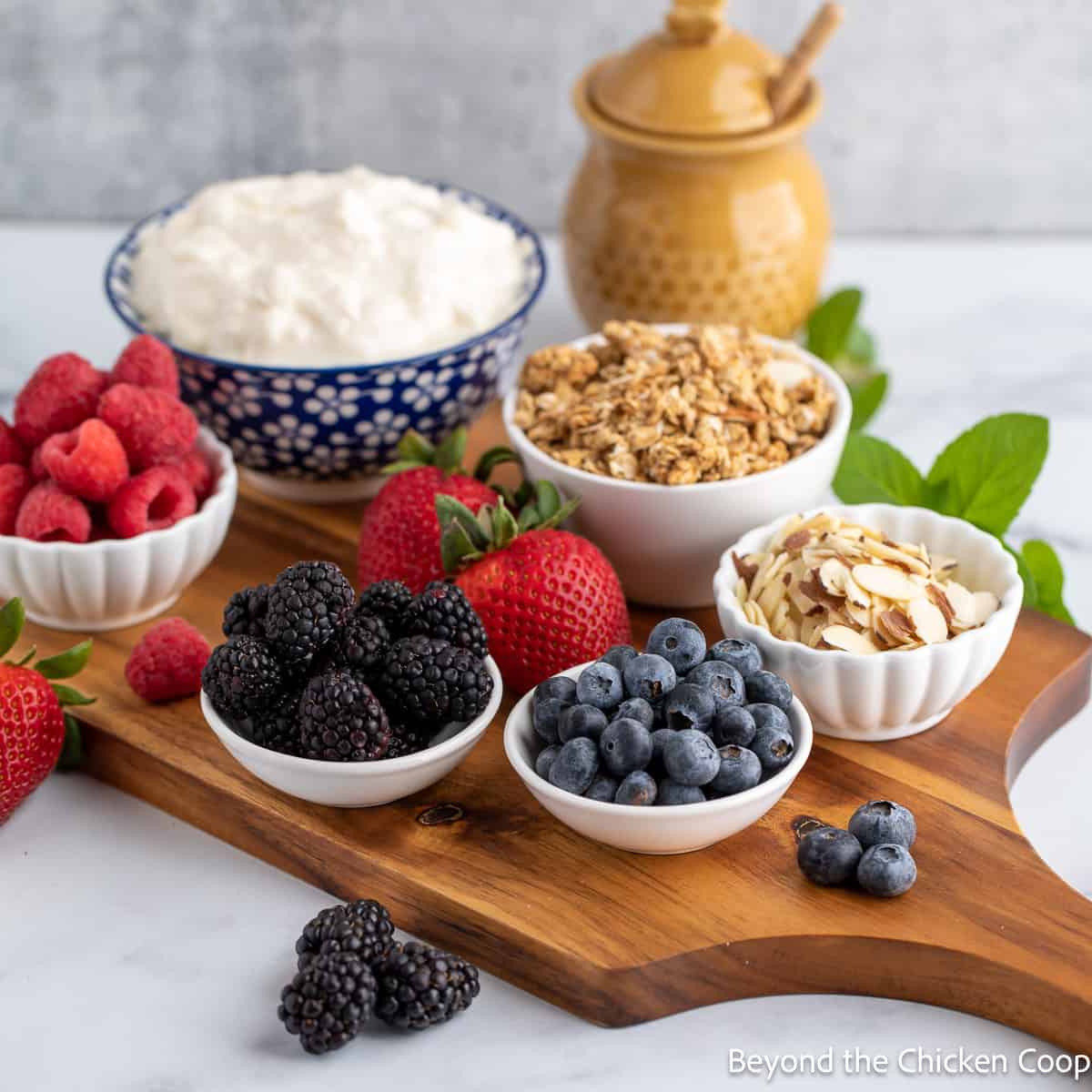 Small bowls with berries, almonds and yogurt. 