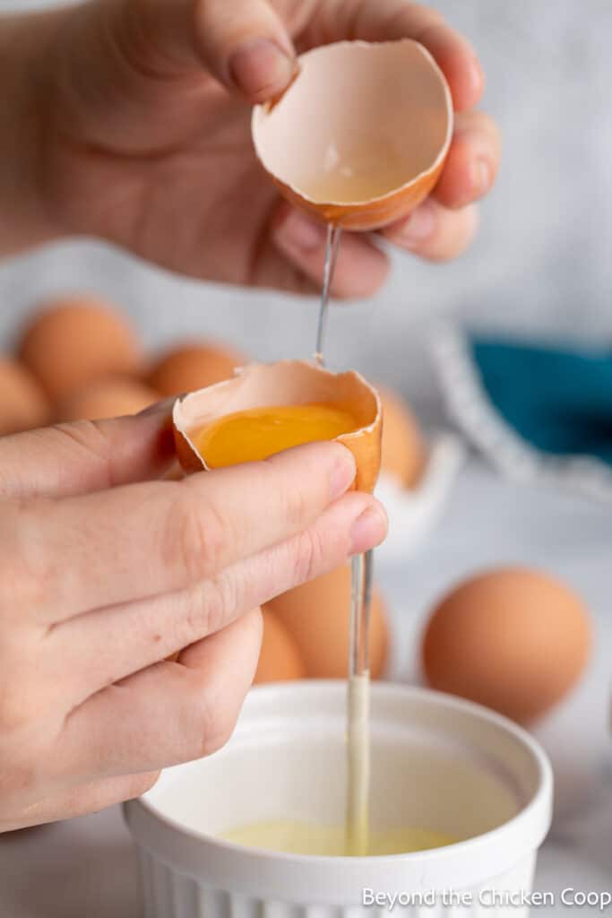 Separating egg whites from yolk in an egg shell. 