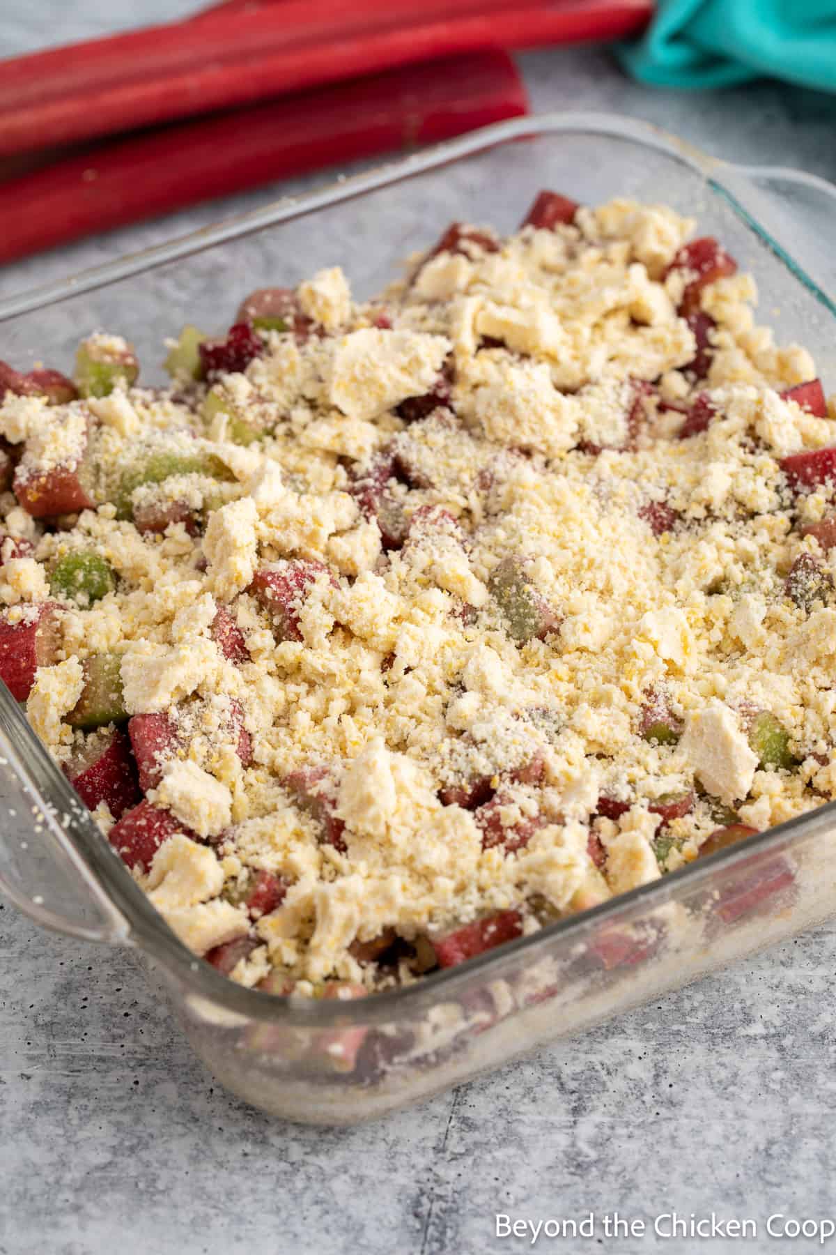 An unbaked rhubarb dessert in a baking dish. 