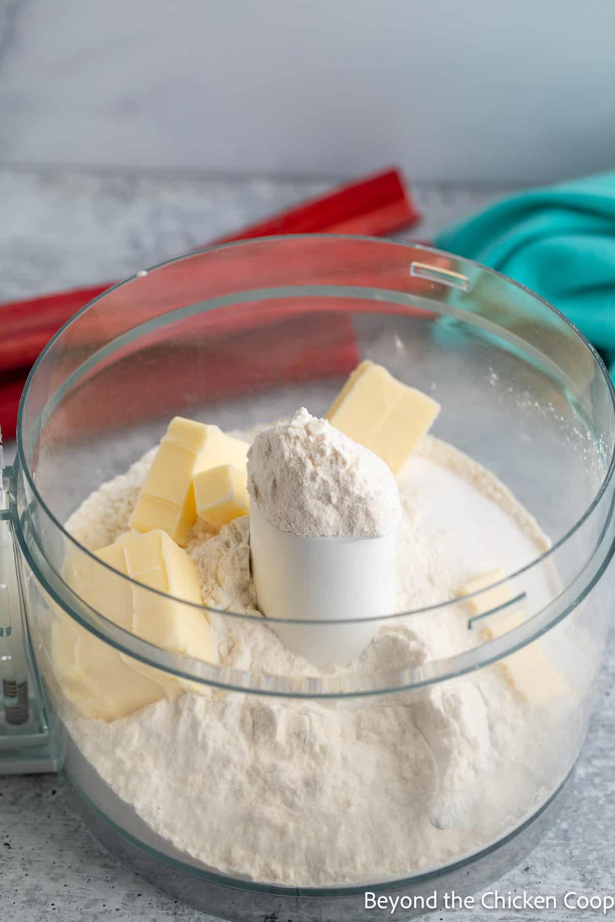 Flour and butter in a food processor bowl. 